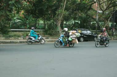 malang, indonesia -19 juli, 2021 : a cyclist crosses the highway on a less crowded road in Malang City