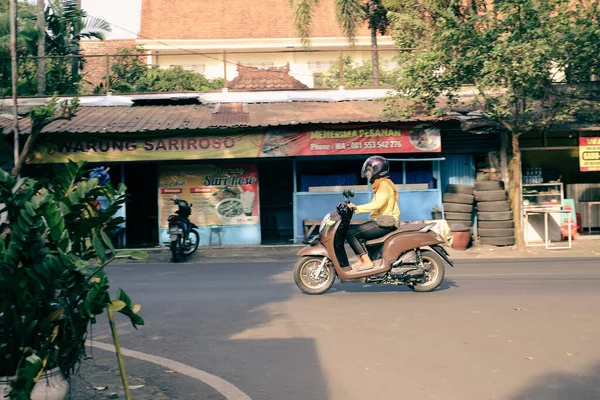 malang, indonesia -19 juli, 2021 : a cyclist crosses the highway on a less crowded road in Malang City