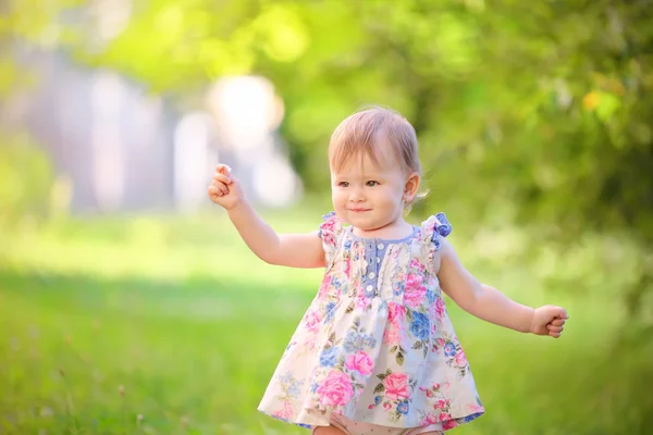 Little girl on a background of green leaves — Stock Photo, Image