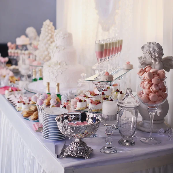 Dessert table for a party. Ombre cake, cupcakes, sweetness and f Stock Picture