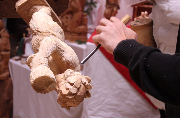wood carver sculpting figure