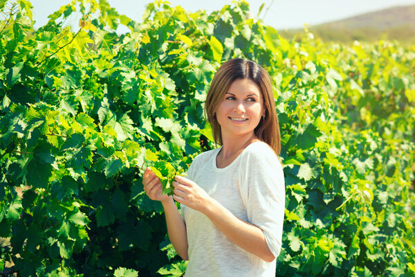 woman  walks on a vineyard