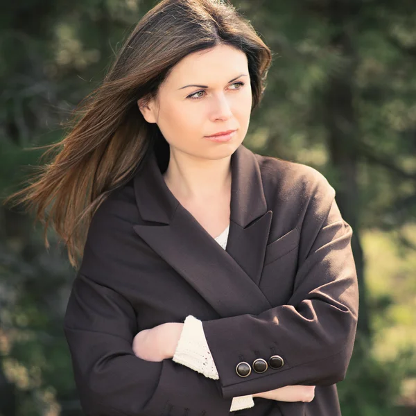 Beautiful girl posing among green trees — Stock Fotó