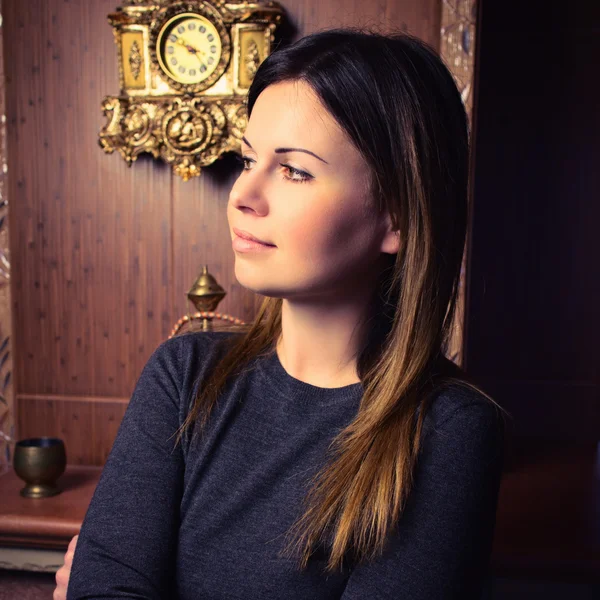 Attractive woman near the fireplace — Stock Photo, Image