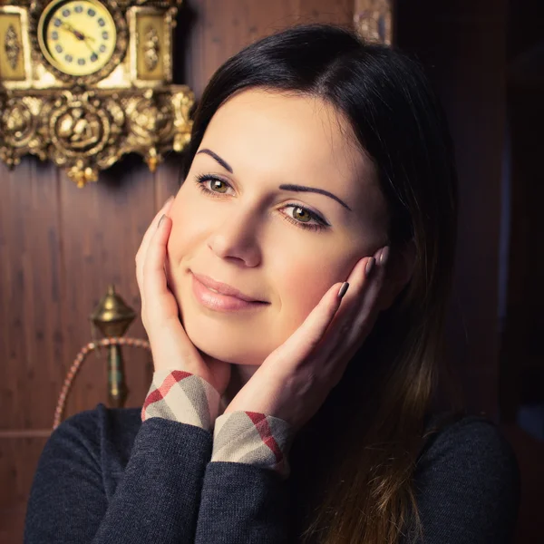 Attractive woman near the fireplace — Stock Photo, Image