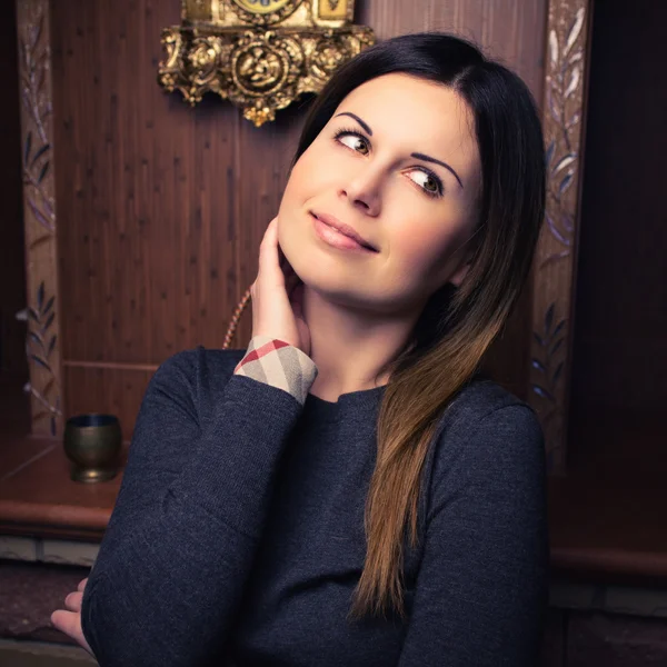 Attractive woman near the fireplace — Stock Photo, Image