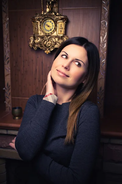 Attractive woman near the fireplace — Stock Photo, Image