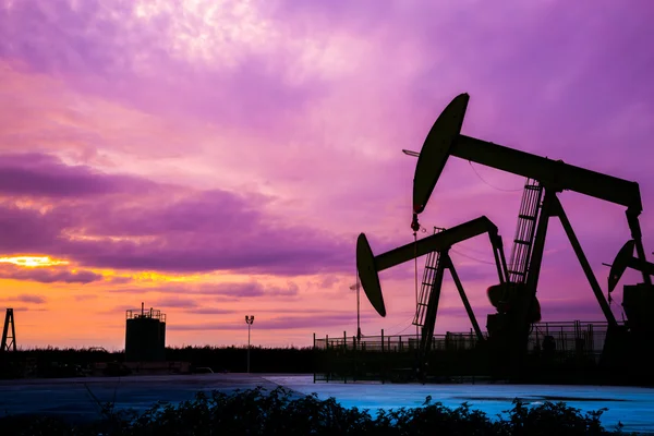 Silhouette of Oil pumps at oil field with sunset sky background — Stock Photo, Image