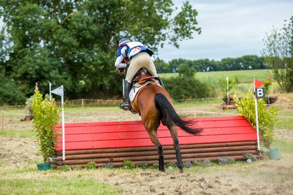 Cavaleiro em seu cavalo galopante durante um evento cross country — Fotografia de Stock