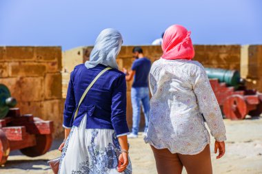 Two females walking along the battlement wall  clipart