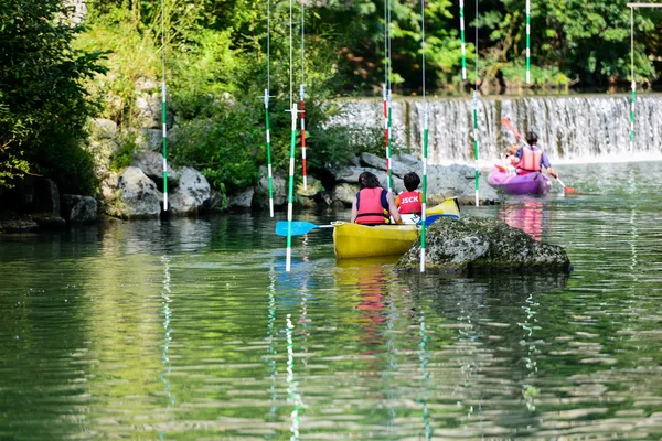 Ungdomar kanot mot små vattenfall — Stockfoto