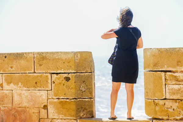 A young woman standing on the rectangular gap between the battle