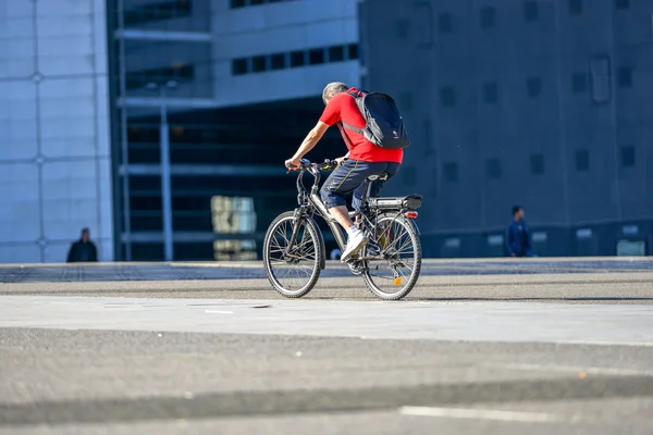 A man cycling in large metropolital area — Stock Photo, Image