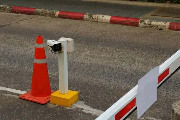 Closeup of security camera installed on upright post fixed to street at security checkpoint for vehicle