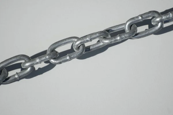 An iron chain hangs on the door. White background with an iron chain.
