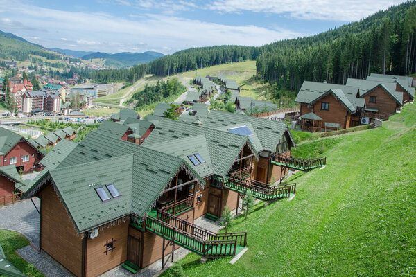 Polianytsia village, Ukraine, July, 31th 2021: Houses and cottages of winter ski resort Bukovel in Carpathian Mountains, Ukraine. Summer view.