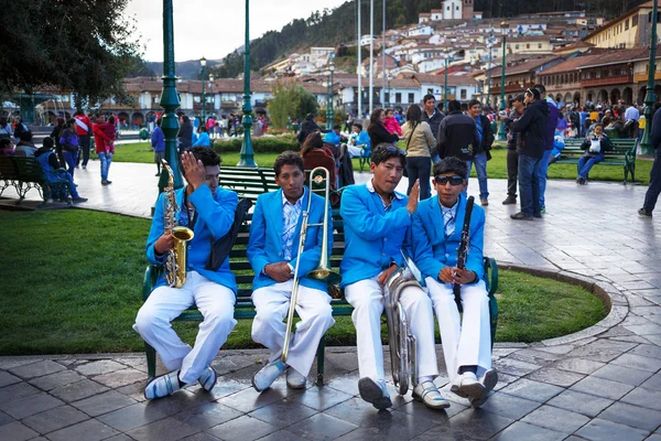 Unknown musicians of a brass band on parade in Cuzco, Peru