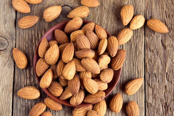 Almonds over rustic wooden background — Stock Photo, Image