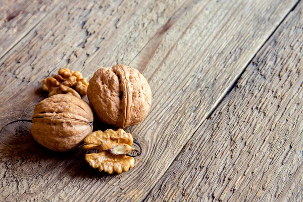 Walnuts on rustic wooden — Stock Photo, Image