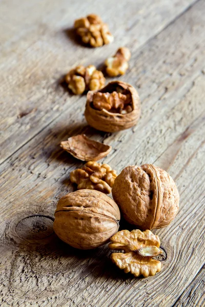 Walnuts on rustic wooden — Stock Photo, Image