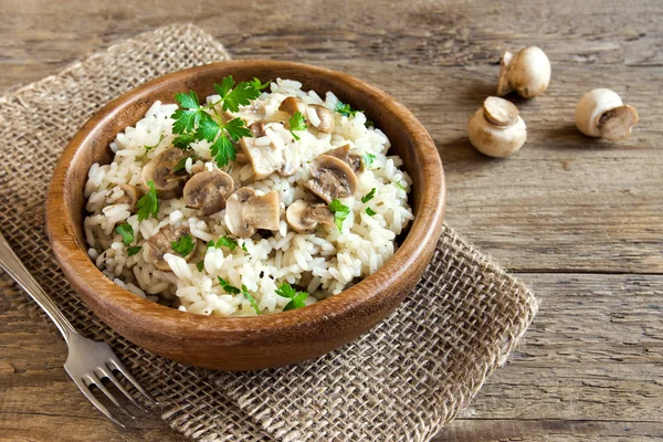 Mushroom risotto in wooden bowl — Stock Photo, Image