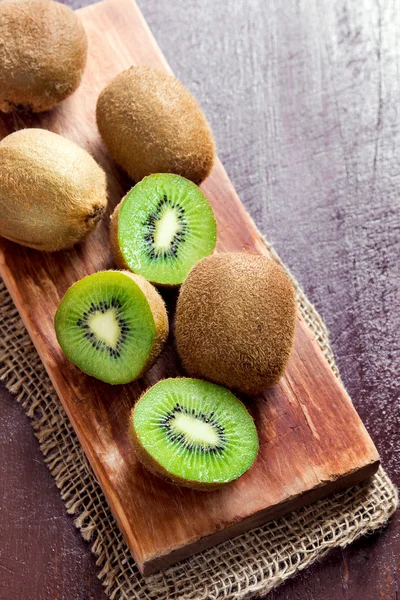 Kiwi fruits on wooden board — Stock Photo, Image