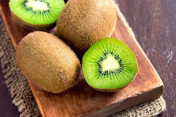 Kiwi fruits on wooden board — Stock Photo, Image