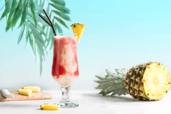 Lava Flow Cocktail - delicious summer tropical drink with rum, strawberry, coconut cream and pineapple juice. Glass of hawaiian cocktail on  light background, copy space.