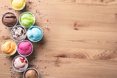 Dondurma çeşitleri. Çeşitli dondurma ya da ahşap arka planda İtalyan dondurması, üst manzara, fotokopi alanı. Küçük bardaklarda donmuş yoğurt - sağlıklı yaz tatlısı.