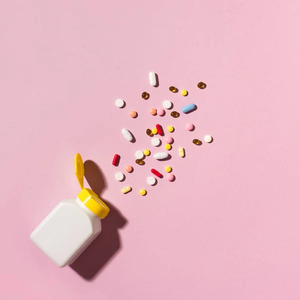 五颜六色的药片 粉色背景的塑料瓶胶囊 复制空间 各种药物片和药片 维生素和营养补充剂概念的堆积如山 — 图库照片