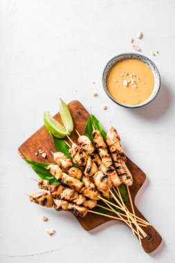 Beyaz üzerine limon ve fıstık soslu ızgara satay şiş tavuk, fotokopi odası. Asya Tayland tarzı yemekler..
