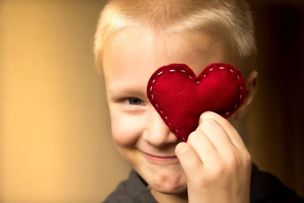 Happy child with red heart — Stock Photo, Image