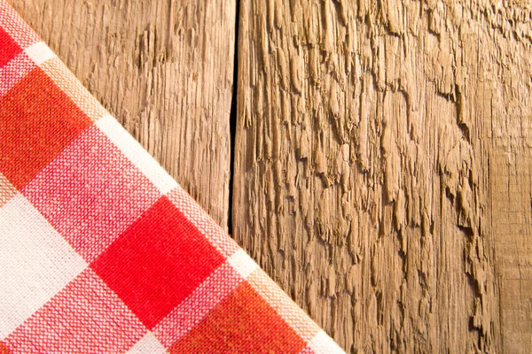 Checkered napkin on wooden bacground — Stock Photo, Image