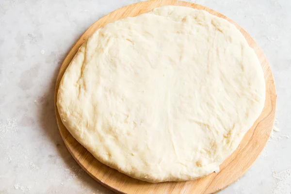 Dough on cutting board — Stock Photo, Image