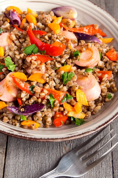 Buckwheat with sausages and vegetables — Stock Photo, Image