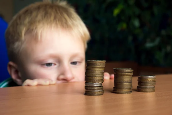 Niño apilar monedas — Foto de Stock