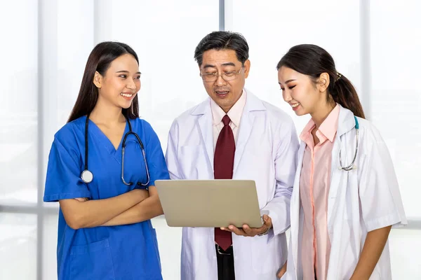 Happy Asian male and female medical doctor team standing and meeting discussion about vaccine with laptop computer