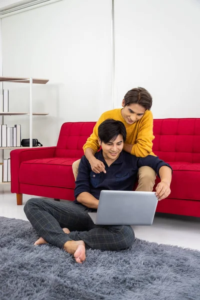 Asian Gay Couple Sitting Sofa Using Laptop Browsing Internet Online Obraz Stockowy