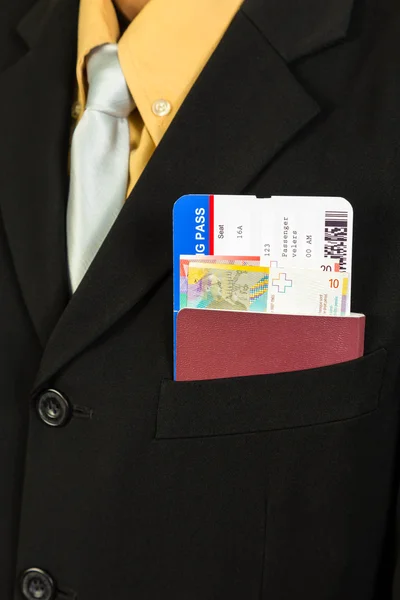 Businessman with passport, boarding pass, and banknote in pocket — Stock Photo, Image