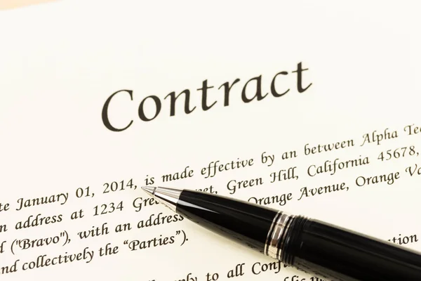 Business contract document on cream color paper focus at pen — Stock Photo, Image