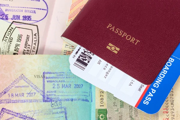 Passport, visa immigration stamps, and boarding pass — Stock Photo, Image