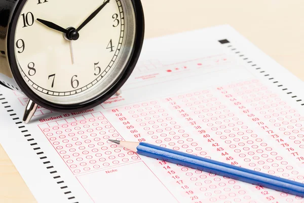 Answer sheet with pencil and alarm clock — Stock Photo, Image