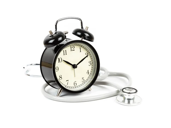 Reloj despertador con concepto de estetoscopio tiempo de atención médica — Foto de Stock