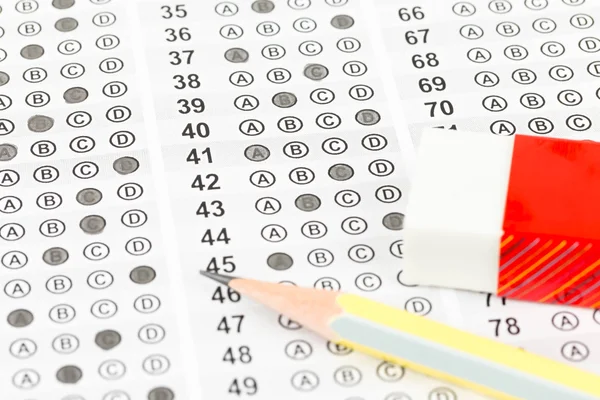 Filled answer sheet with eraser and pencil — Stock Photo, Image