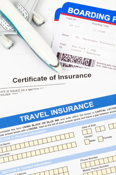 Travel insurance application form with plane model and boarding — Stok fotoğraf