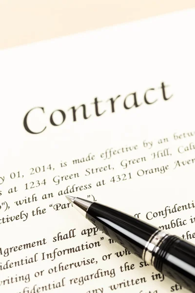 Business contract document on cream color paper focus at pen — Stock Photo, Image