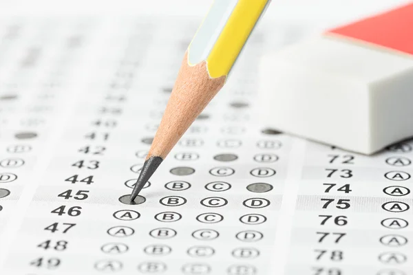 Filled answer sheet with eraser focus on pencil — Stock Photo, Image