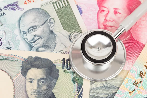 Stethoscope on asian banknote concept financial health check — Stock Photo, Image