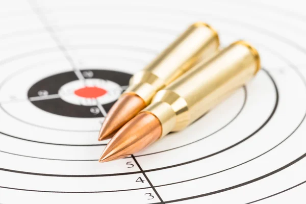 Rifle bullet over target background — Stock Photo, Image