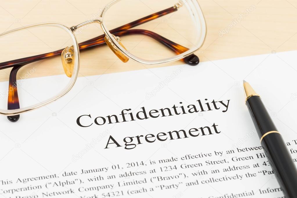 Confidentiality agreement document with glasses close-up